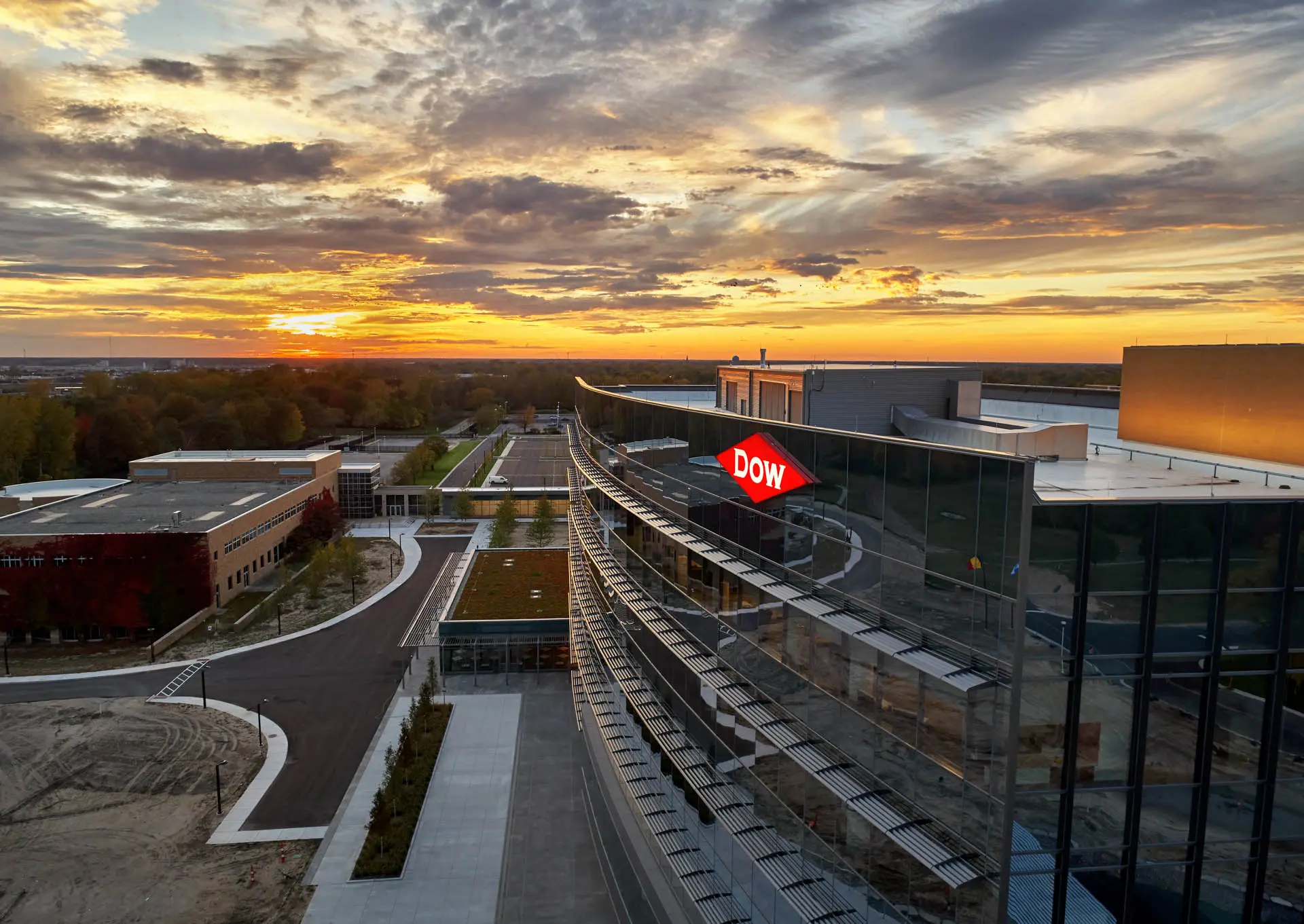 Aerial view of a modern Dow corporate building at sunset.