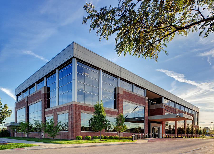 Modern brick and glass medical office building with landscaped grounds.